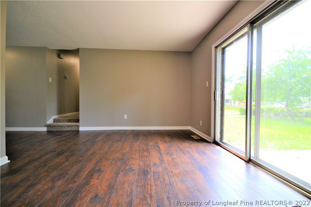 5201 Brookfield Road Fayetteville, NC 28303 - Photo 11 of 45 an empty room with wooden floor and windows
