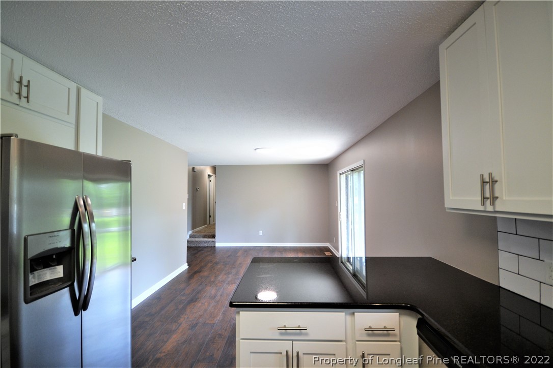 5201 Brookfield Road Fayetteville, NC 28303 - Photo 17 of 45 a kitchen with stainless steel appliances granite countertop a refrigerator a stove and a sink