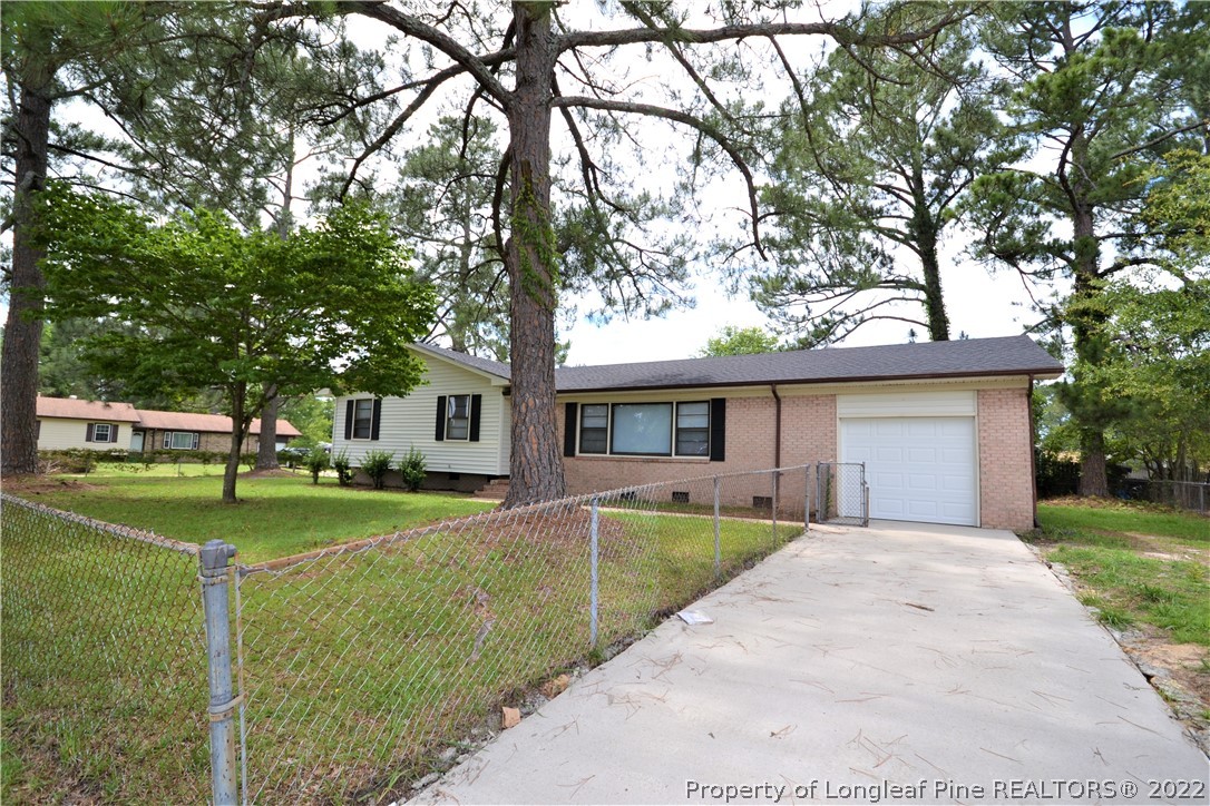 5201 Brookfield Road Fayetteville, NC 28303 - Photo 2 of 45 a front view of a house with a yard and trees