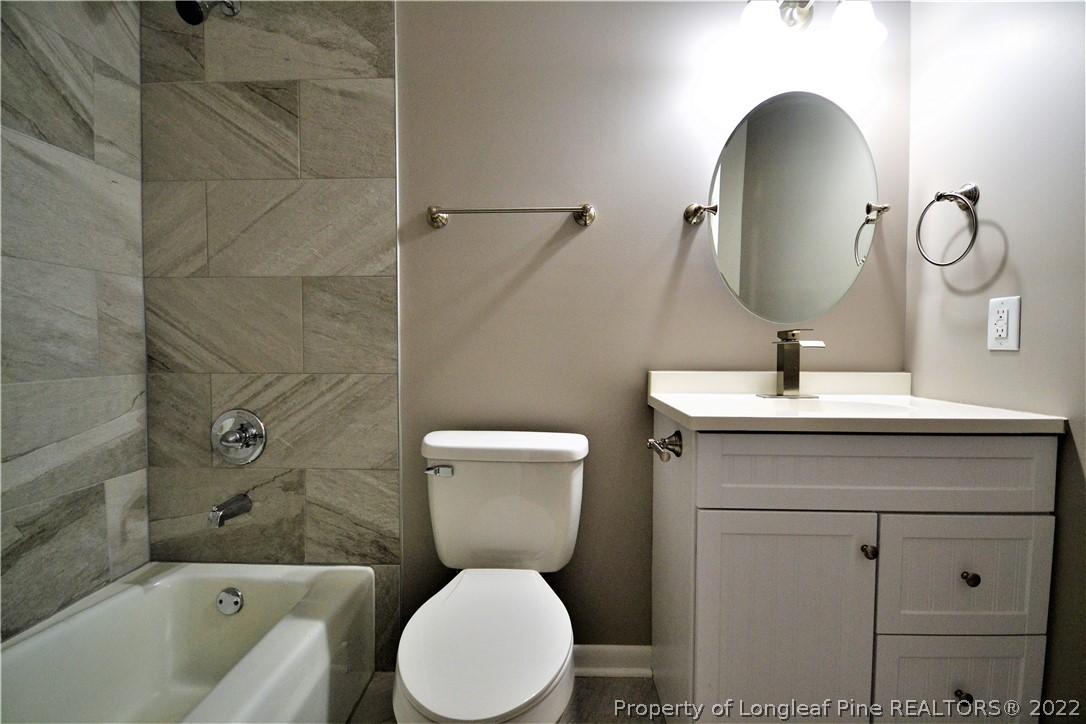 5201 Brookfield Road Fayetteville, NC 28303 - Photo 22 of 45 a bathroom with a toilet sink and mirror