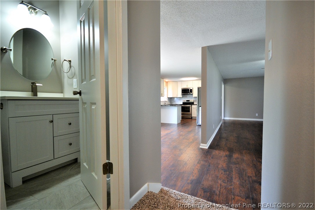 5201 Brookfield Road Fayetteville, NC 28303 - Photo 23 of 45 a view of a hallway with wooden floor windows and a bathroom