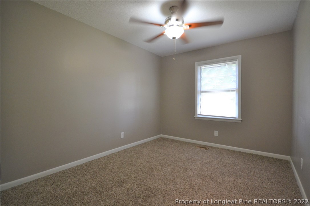 5201 Brookfield Road Fayetteville, NC 28303 - Photo 24 of 45 an empty room with a window and a ceiling fan