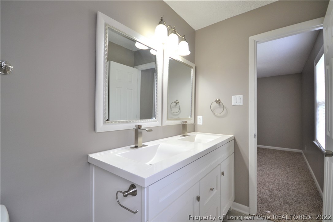 5201 Brookfield Road Fayetteville, NC 28303 - Photo 35 of 45 a bathroom with a sink and a mirror