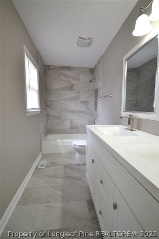 5201 Brookfield Road Fayetteville, NC 28303 - Photo 36 of 45 a bathroom with a sink a toilet and mirror