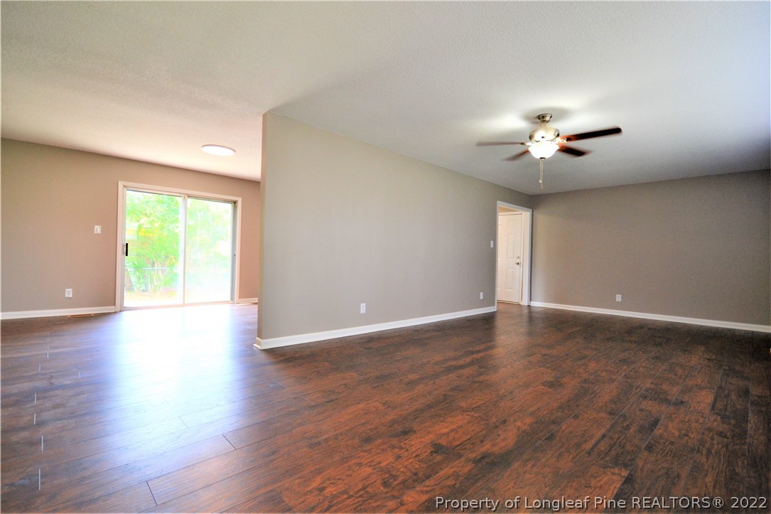 5201 Brookfield Road Fayetteville, NC 28303 - Photo 9 of 45 a view of an empty room with a window and wooden floor