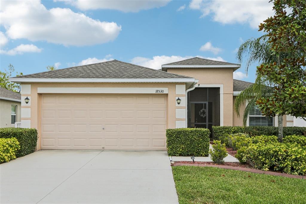 a front view of a house with a yard and garage