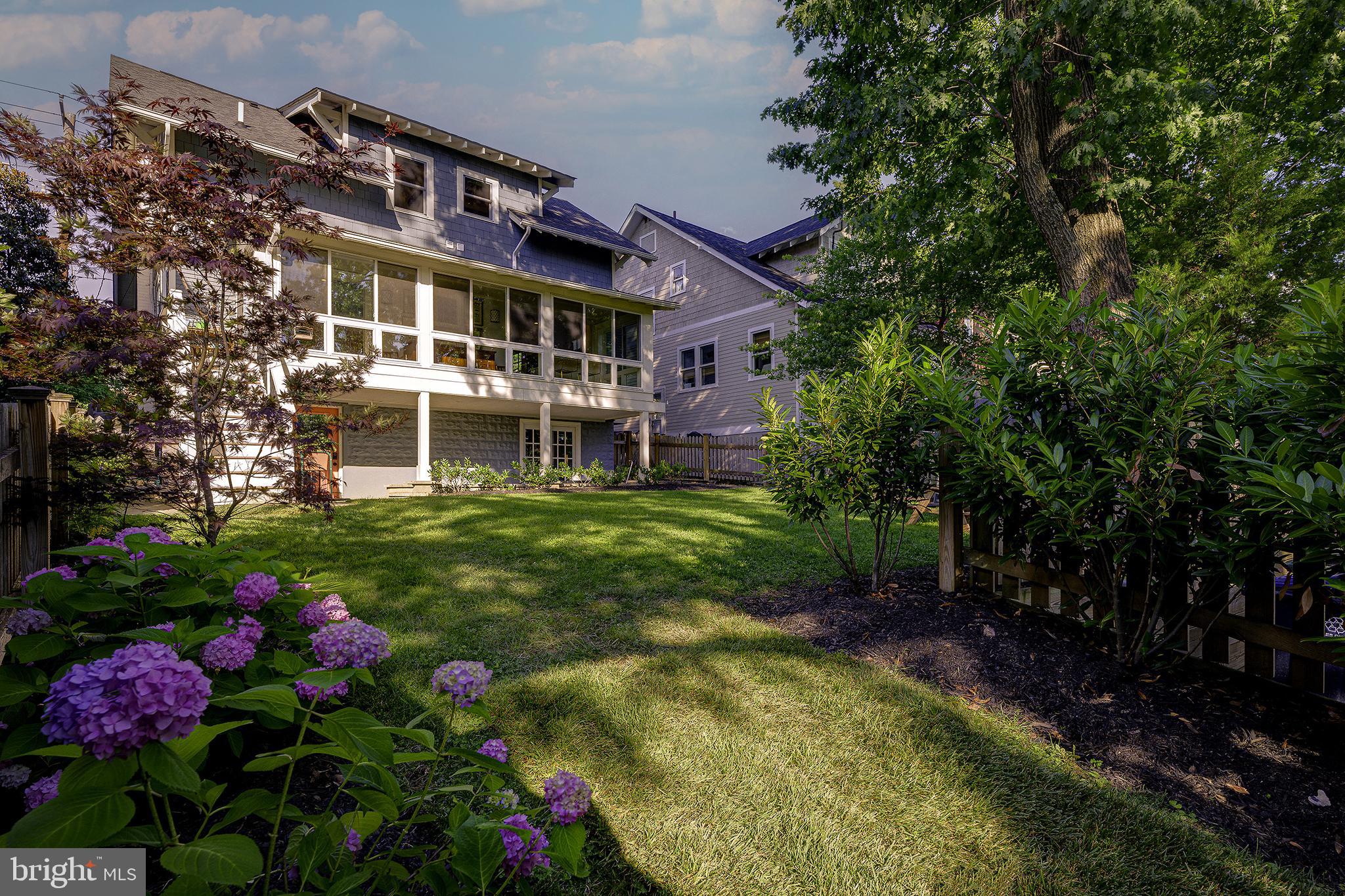 5710 Broad Branch Road Northwest Washington, DC 20015 - Photo 21 of 25 a view of a house with a big yard and large trees
