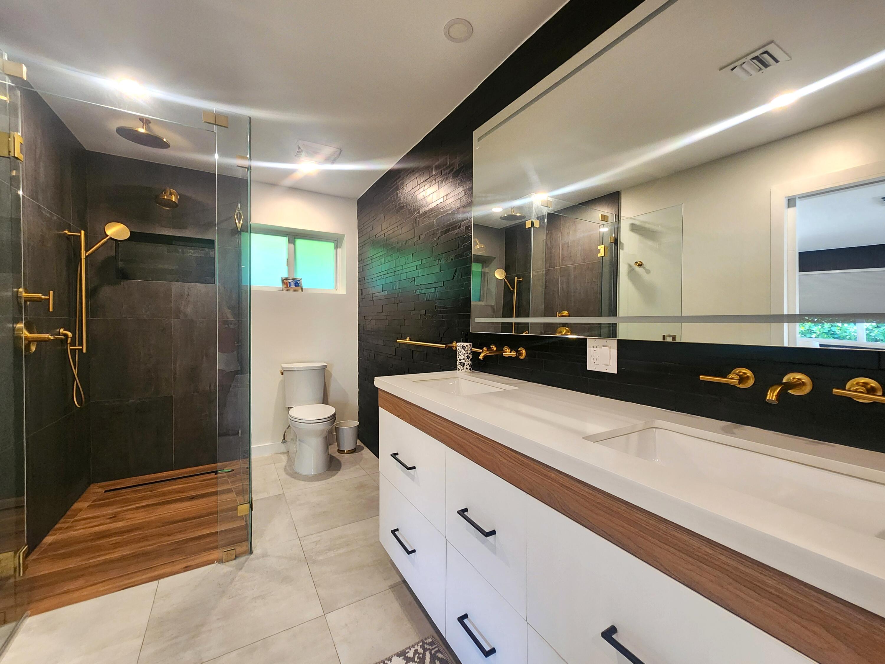 3481 Northeast 31st Avenue Lighthouse Point, FL 33064 - Photo 11 of 27 a bathroom with a sink and mirror