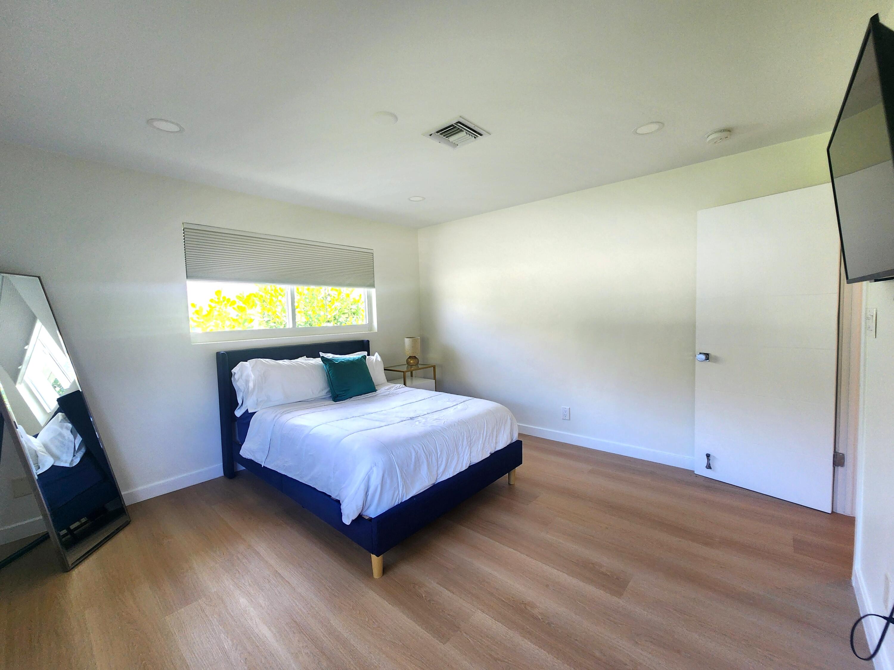 3481 Northeast 31st Avenue Lighthouse Point, FL 33064 - Photo 17 of 27 a bedroom with a bed and a window
