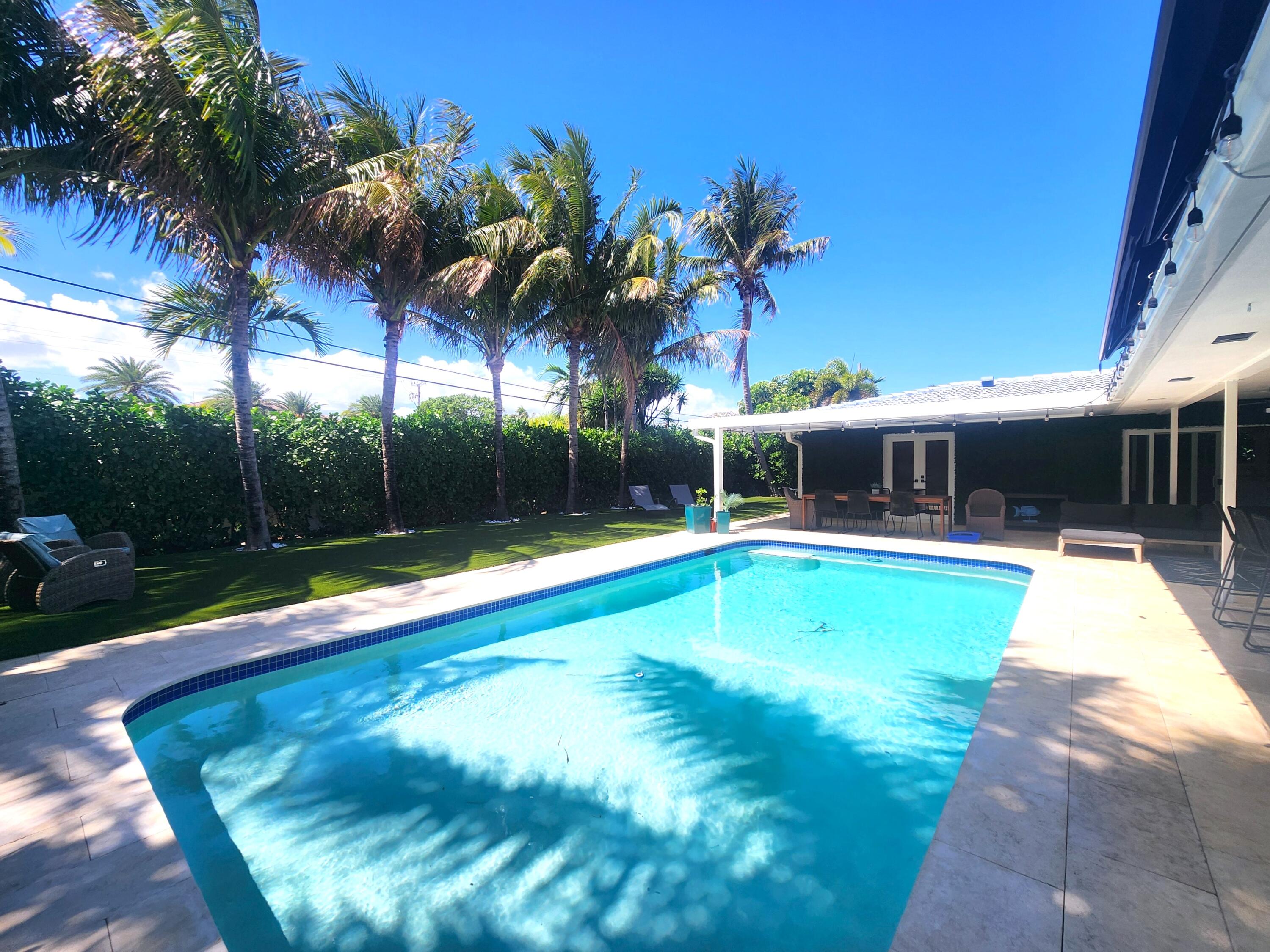 3481 Northeast 31st Avenue Lighthouse Point, FL 33064 - Photo 21 of 27 a view of swimming pool with palm trees