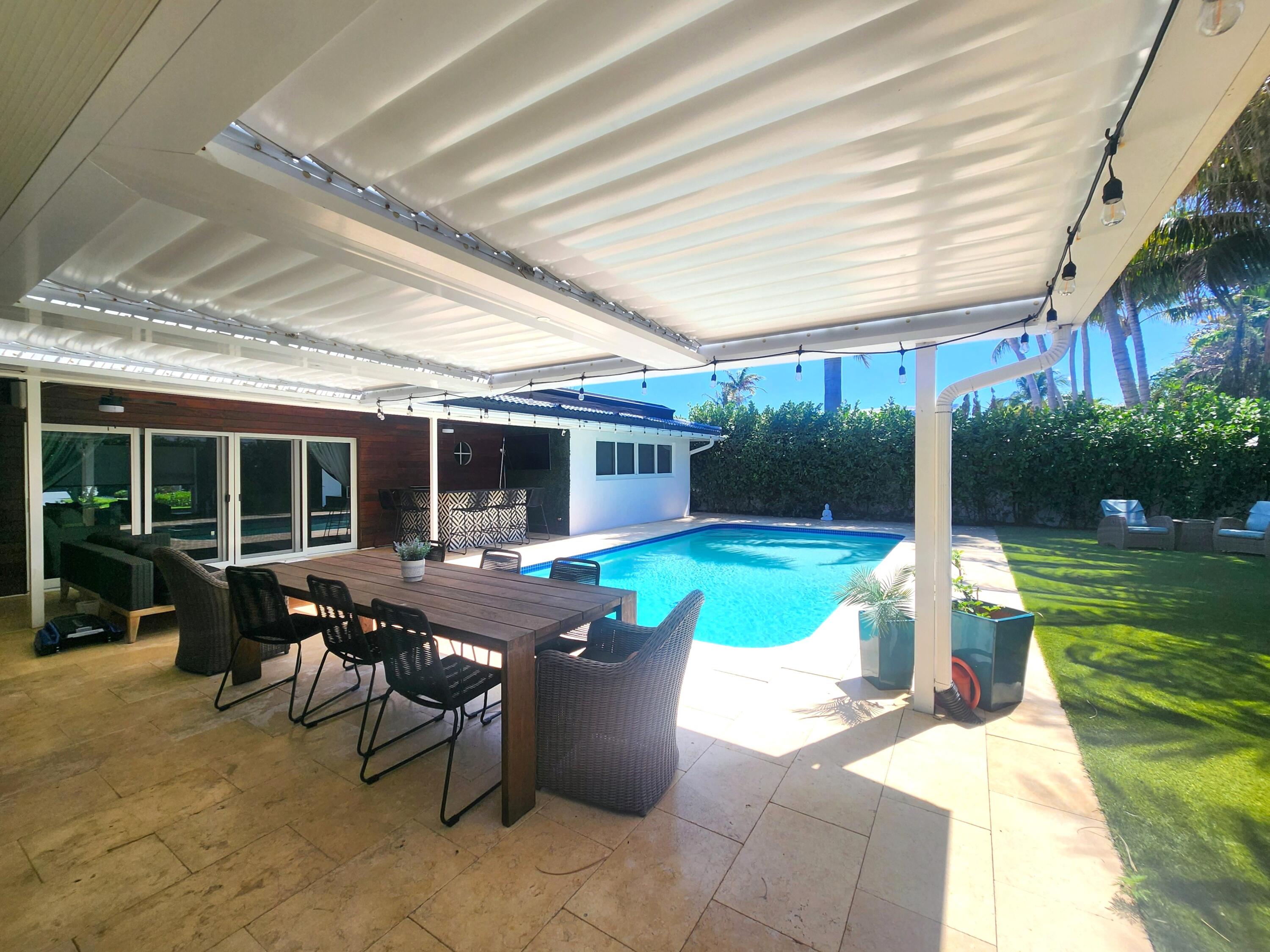 3481 Northeast 31st Avenue Lighthouse Point, FL 33064 - Photo 24 of 27 a view of a house with backyard sitting area and swimming pool