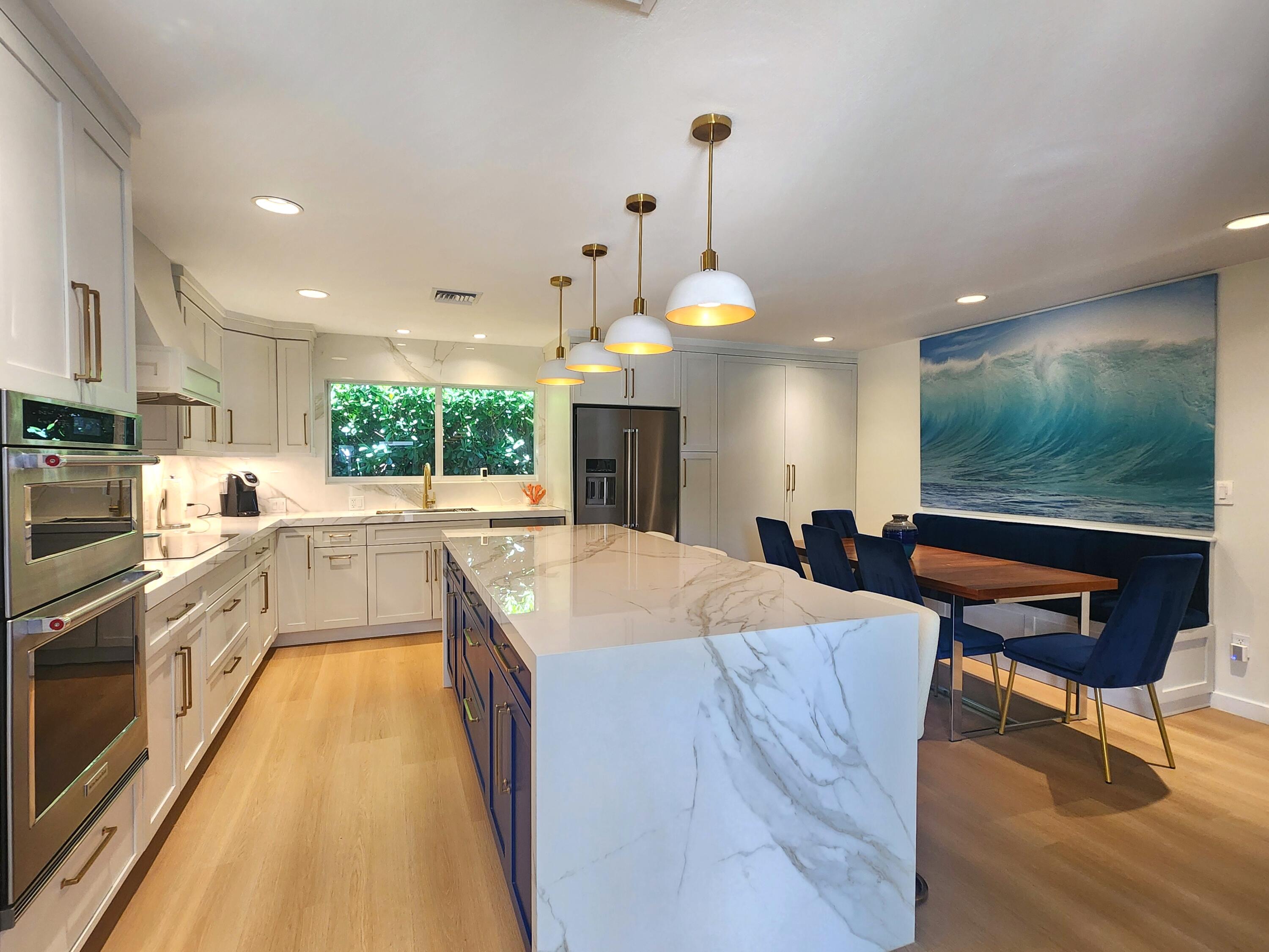 3481 Northeast 31st Avenue Lighthouse Point, FL 33064 - Photo 6 of 27 a large kitchen with stainless steel appliances kitchen island granite countertop a sink and cabinets