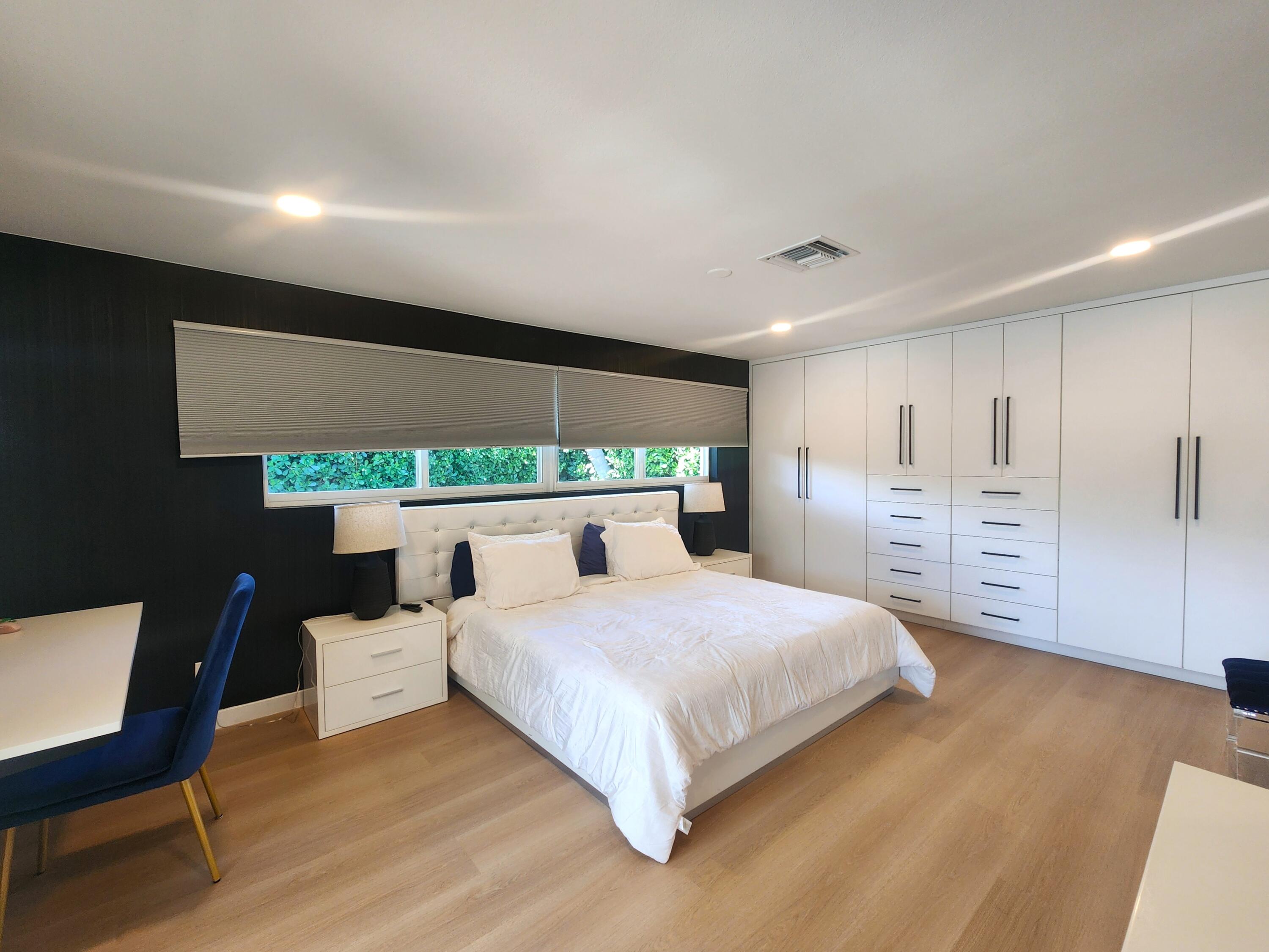 3481 Northeast 31st Avenue Lighthouse Point, FL 33064 - Photo 7 of 27 a bedroom with a bed and a chair
