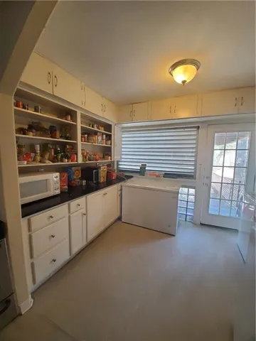 a kitchen with granite countertop a sink and cabinets