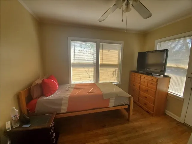 a bedroom with a bed and flat screen tv