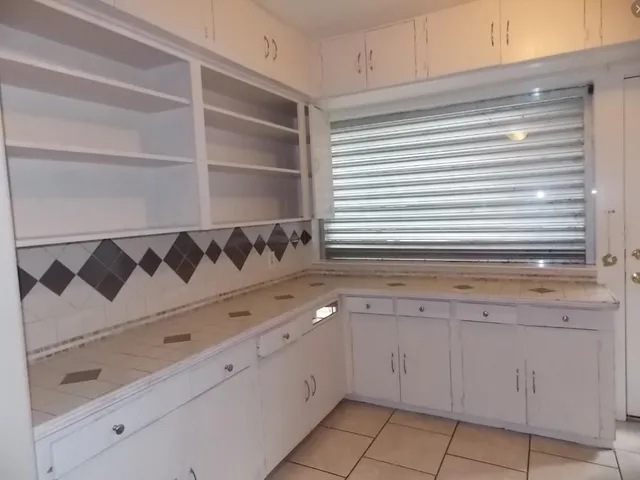 a kitchen with a sink and cabinets