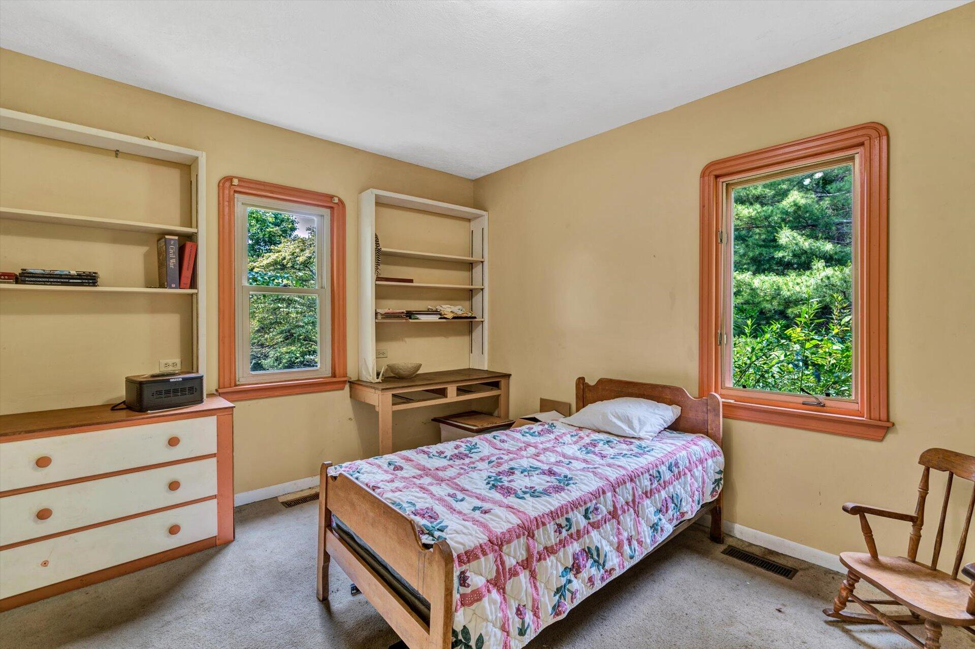 953 Huffville Road Northeast Pilot, VA 24138 - Photo 14 of 38 a bedroom with a bed and a dresser next to a window