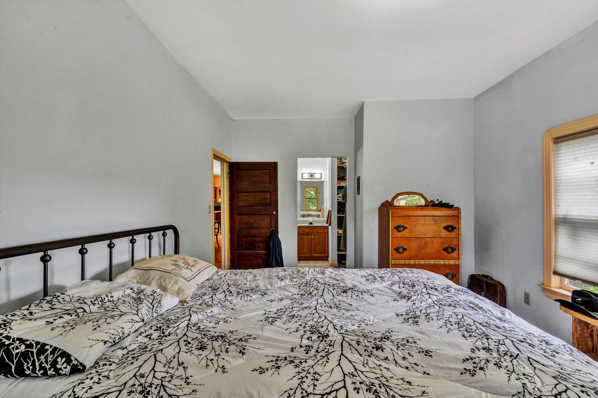 953 Huffville Road Northeast Pilot, VA 24138 - Photo 16 of 38 a bedroom with a bed and a flat tv screen on dresser