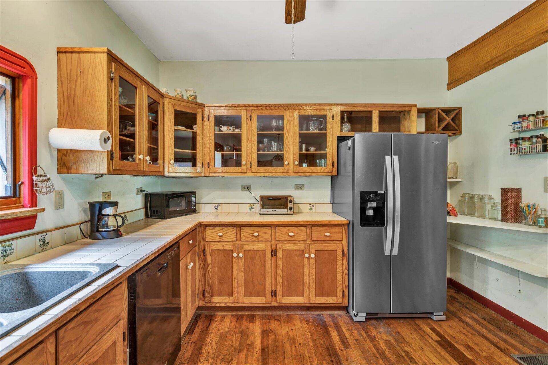 953 Huffville Road Northeast Pilot, VA 24138 - Photo 10 of 38 a kitchen with stainless steel appliances granite countertop a refrigerator a sink dishwasher and wooden cabinets with wooden floor