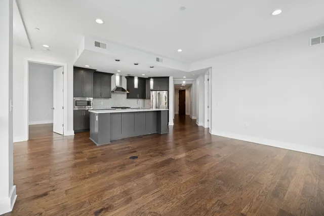 a bedroom with a large bed and ceiling fan