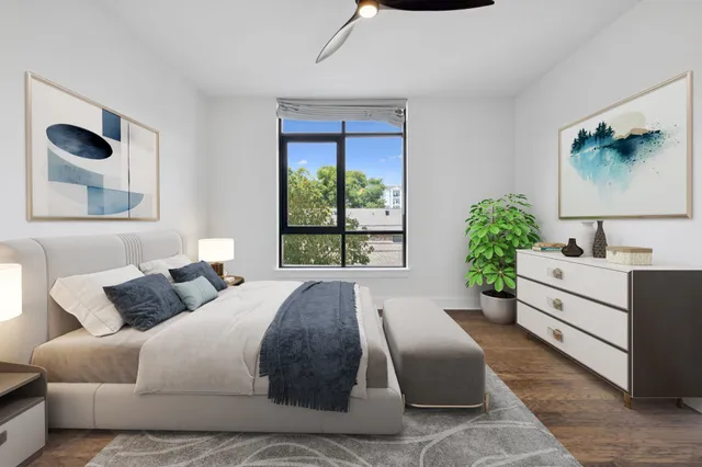 a spacious bathroom with a granite countertop sink a toilet a mirror and shower