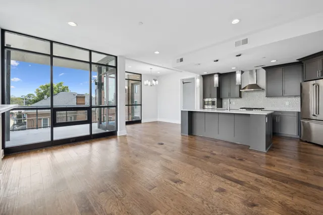a living room with furniture fireplace and a large window