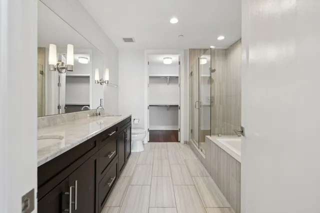 a bathroom with a sink vanity and toilet