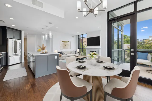 a view of a dining room with furniture wooden floor and chandelier