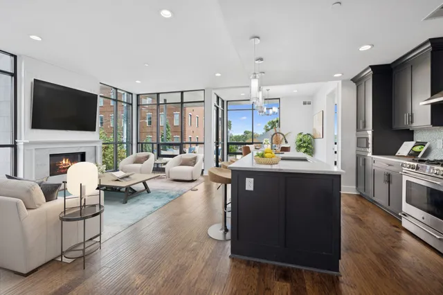 a kitchen with stainless steel appliances a sink and a refrigerator