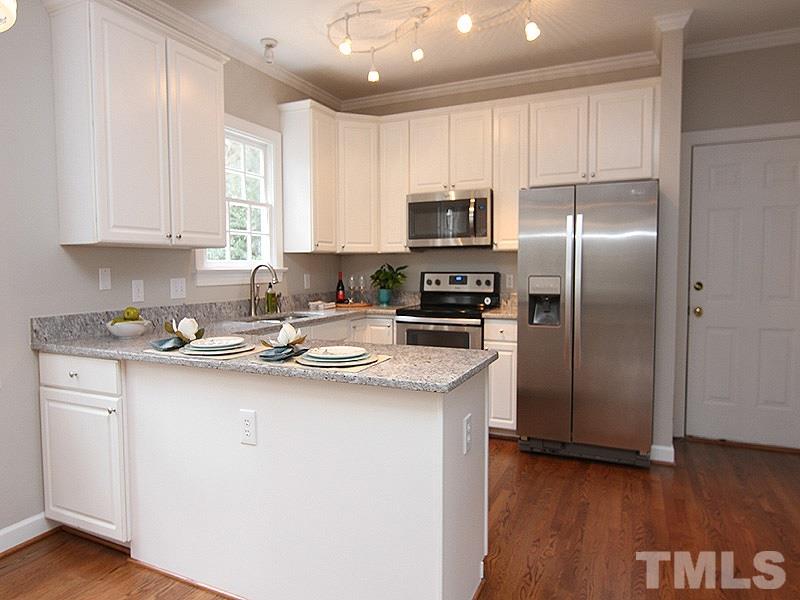 2617 Jasper Lane Raleigh, NC 27613 - Photo 11 of 25 a kitchen with stainless steel appliances granite countertop a refrigerator sink and microwave