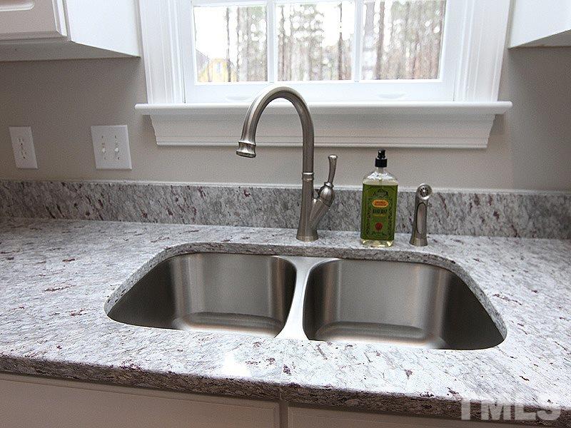2617 Jasper Lane Raleigh, NC 27613 - Photo 13 of 25 a kitchen with granite countertop a sink and a stove