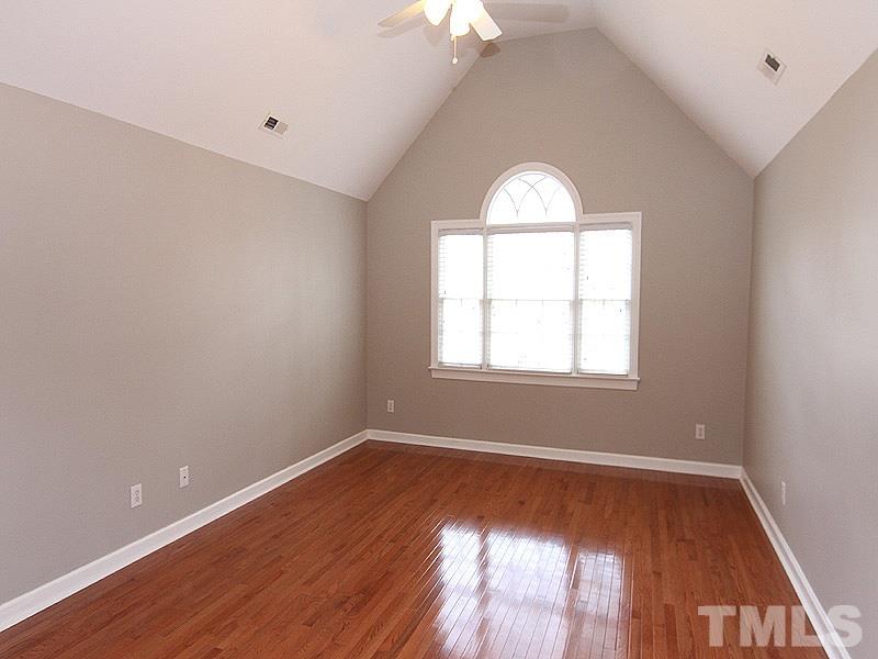 2617 Jasper Lane Raleigh, NC 27613 - Photo 15 of 25 an empty room with wooden floor and windows