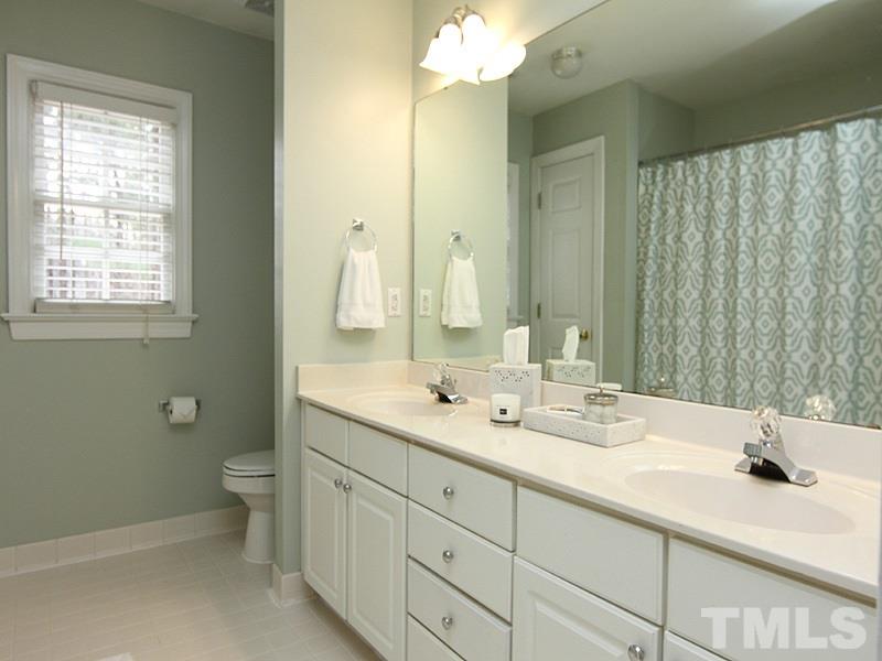 2617 Jasper Lane Raleigh, NC 27613 - Photo 20 of 25 a bathroom with a double vanity sink mirror and toilet