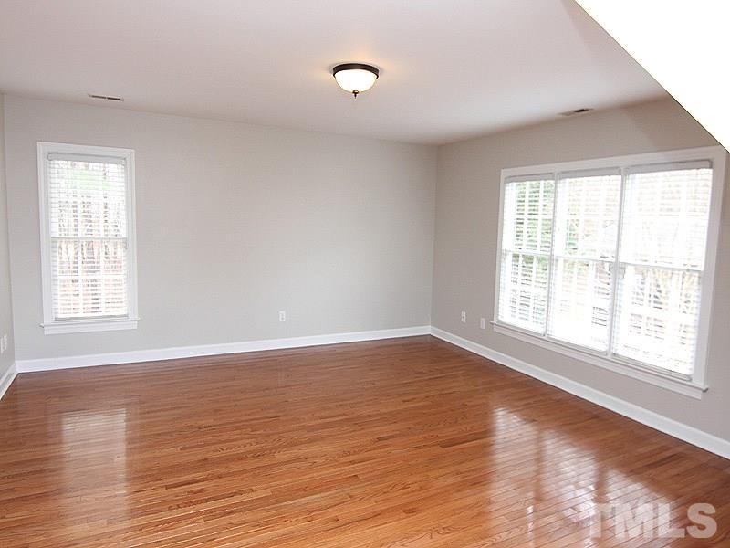 2617 Jasper Lane Raleigh, NC 27613 - Photo 22 of 25 a view of an empty room with wooden floor and a window
