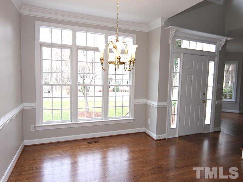 2617 Jasper Lane Raleigh, NC 27613 - Photo 5 of 25 a view of an empty room with wooden floor and a window