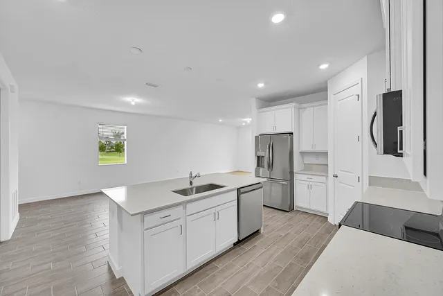 a kitchen with a sink and refrigerator