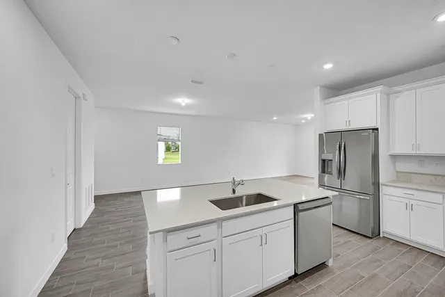 a kitchen with a sink stainless steel appliances and cabinets