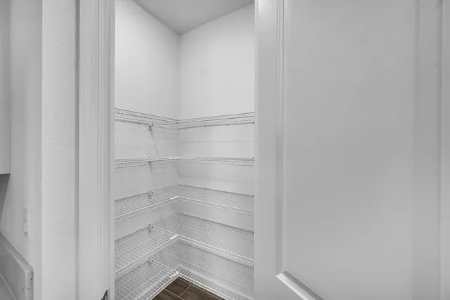 a walk in closet with empty racks
