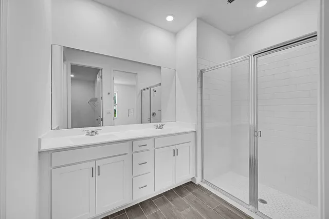 a bathroom with a double vanity sink and mirror