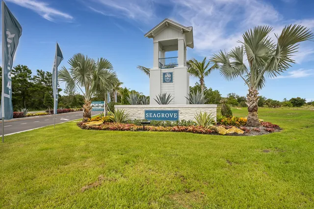 a view of a swimming swimming pool with lawn chairs and a big yard