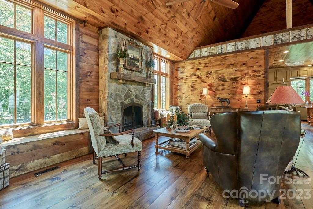 800 Collinsville Road Columbus, NC 28722 - Photo 18 of 33 a living room with furniture a fireplace and a floor to ceiling window