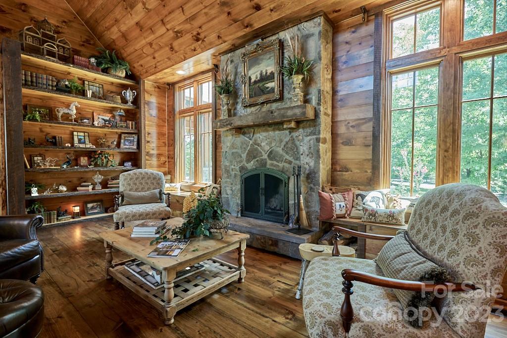 800 Collinsville Road Columbus, NC 28722 - Photo 19 of 33 a living room with furniture a fireplace and a floor to ceiling window