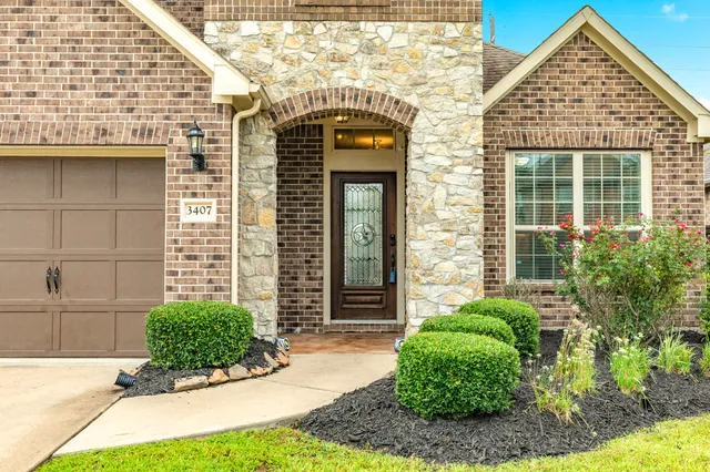 a view of a brick house with potted plants