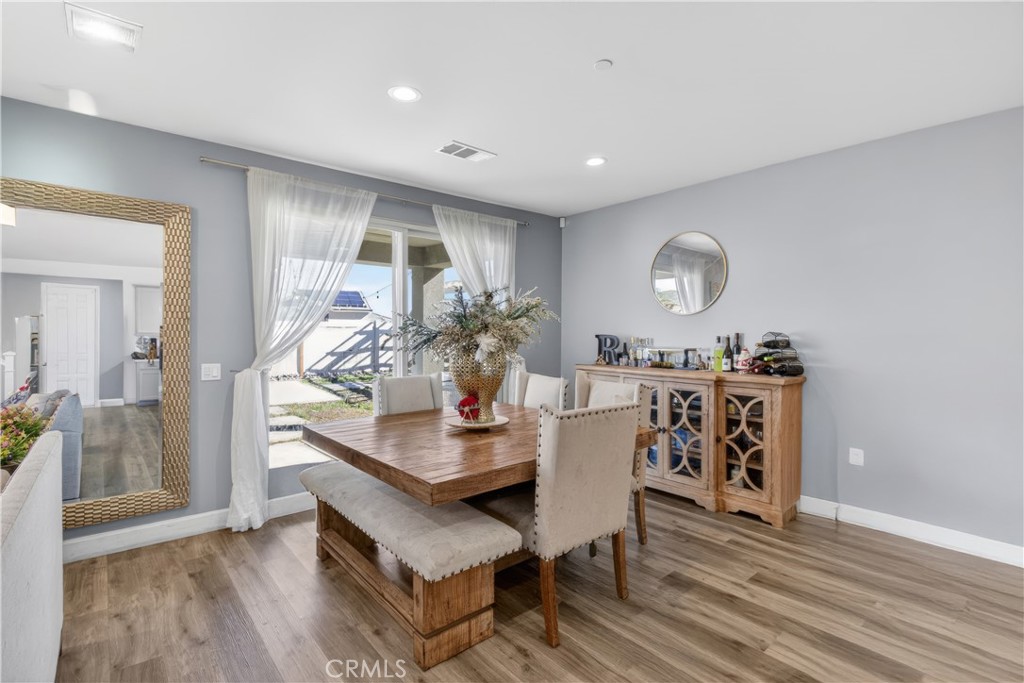 29608 Laredo Circle Menifee, CA 92584 - Photo 14 of 51 a dining room with furniture and wooden floor
