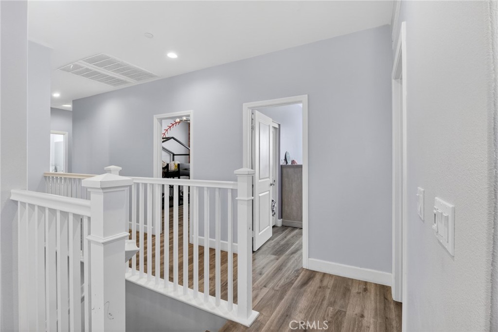 29608 Laredo Circle Menifee, CA 92584 - Photo 25 of 51 a view of a hallway with a white door and stairs