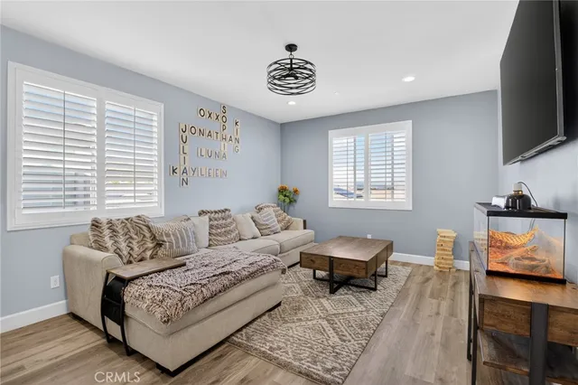 a bedroom with furniture and a flat screen tv