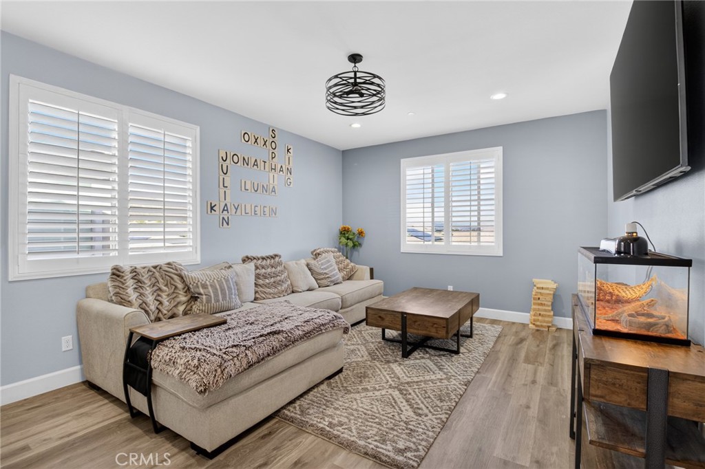 29608 Laredo Circle Menifee, CA 92584 - Photo 26 of 51 a living room with furniture and a flat screen tv