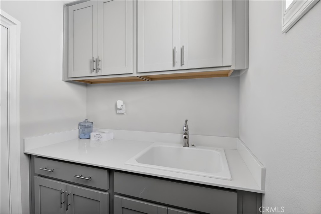 29608 Laredo Circle Menifee, CA 92584 - Photo 34 of 51 a bathroom with a sink and cabinets