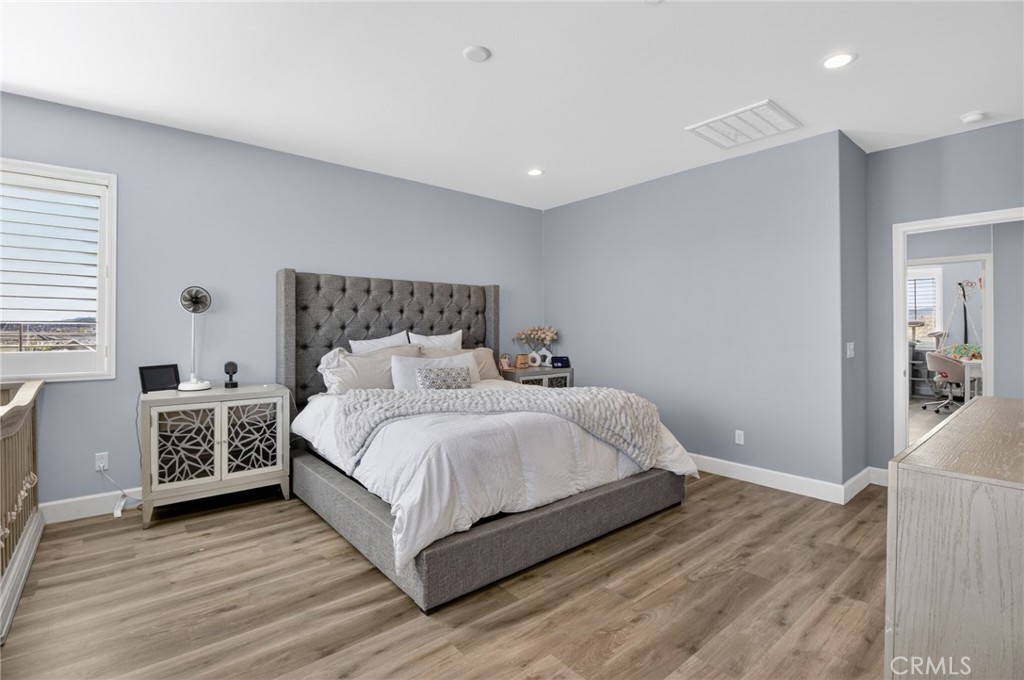 29608 Laredo Circle Menifee, CA 92584 - Photo 37 of 51 a bedroom with a bed and a night stand