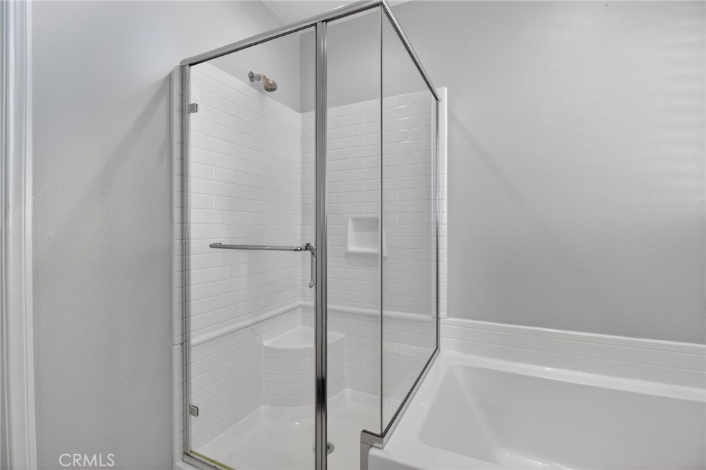 29608 Laredo Circle Menifee, CA 92584 - Photo 41 of 51 a bathroom with a glass shower door